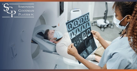 Tech looking at charts while patient enters CT Scan