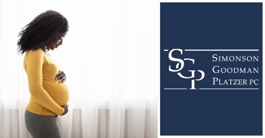 Pregnant African American Woman Looking at Baby Bump